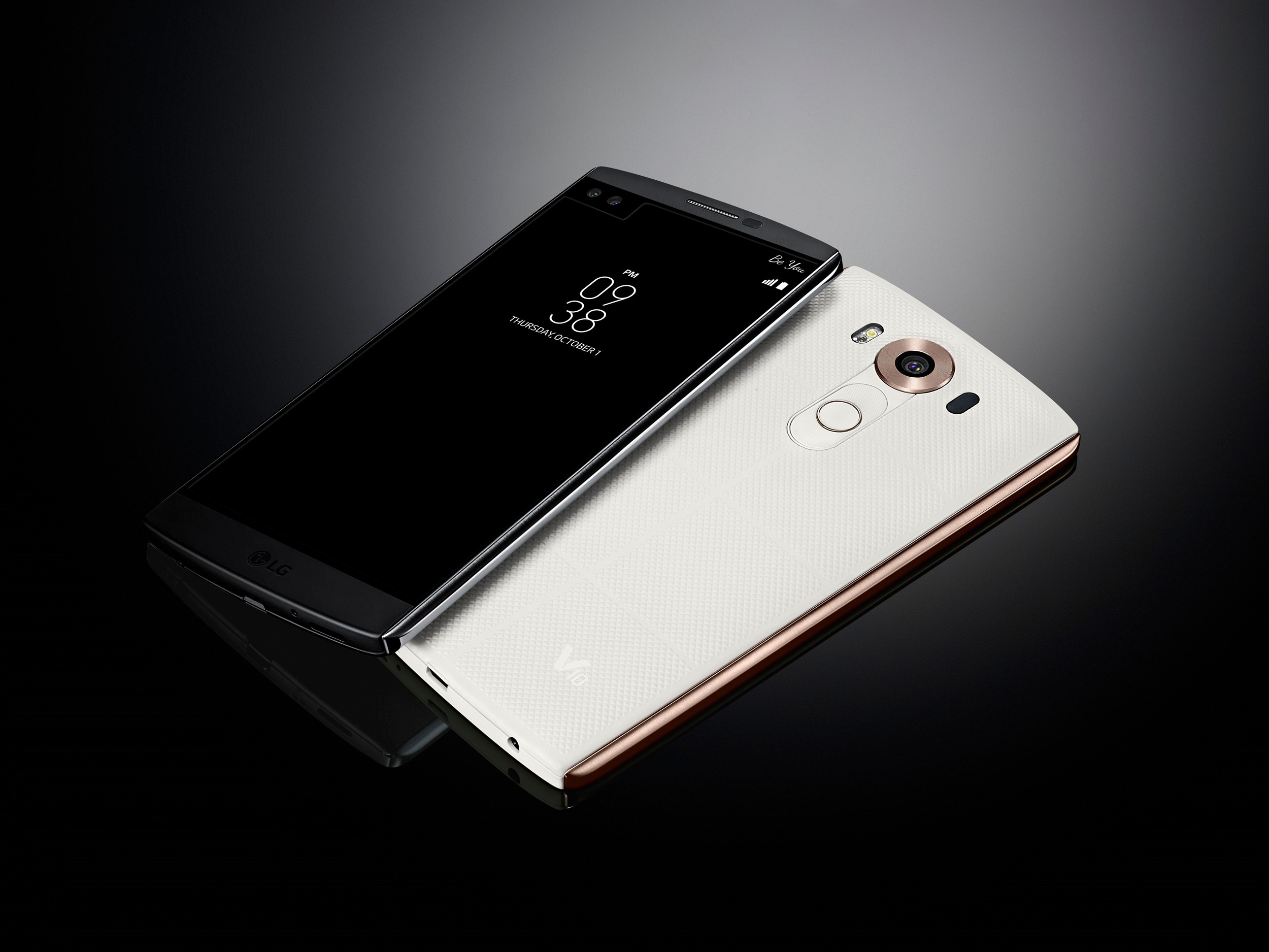 The LG V10 in Space Black lying right-side up and the same device in Luxe White upside-down