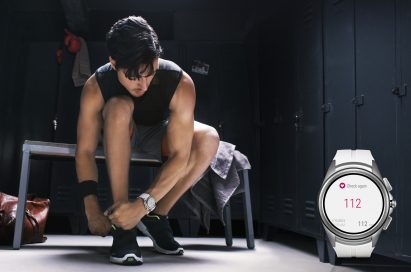 A man looks at the LG Watch Urbane 2nd Edition on his wrist to check his heart rate while tying his shoes