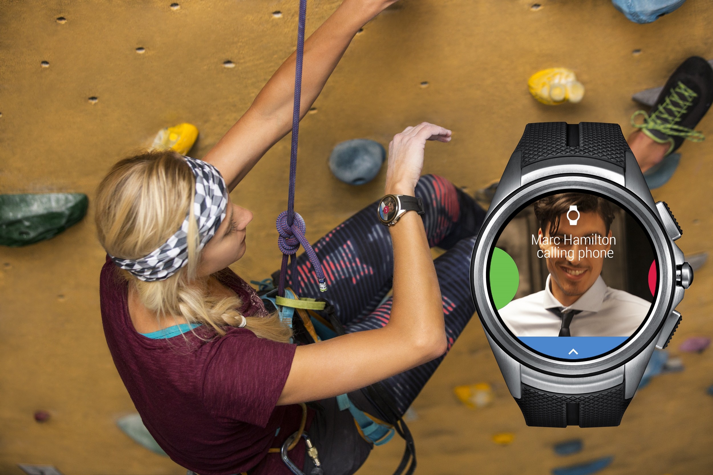 A woman looks at the LG Watch Urbane 2nd Edition on her wrist to receive an incoming call while rock climbing