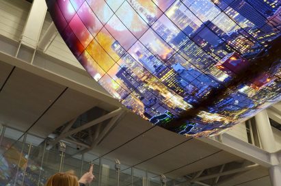 A ceiling installation of LG OLED Signage displaying a city’s skyline at night on display at Incheon International Airport