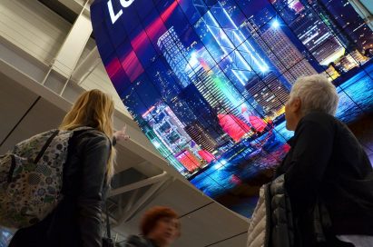 A ceiling installation of LG OLED Signage displaying a city’s skyline at night on display at Incheon International Airport
