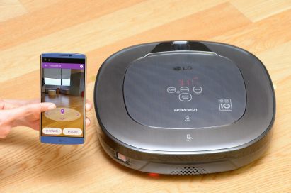 LG HOM-BOT and smartphone with hand visible showing its location