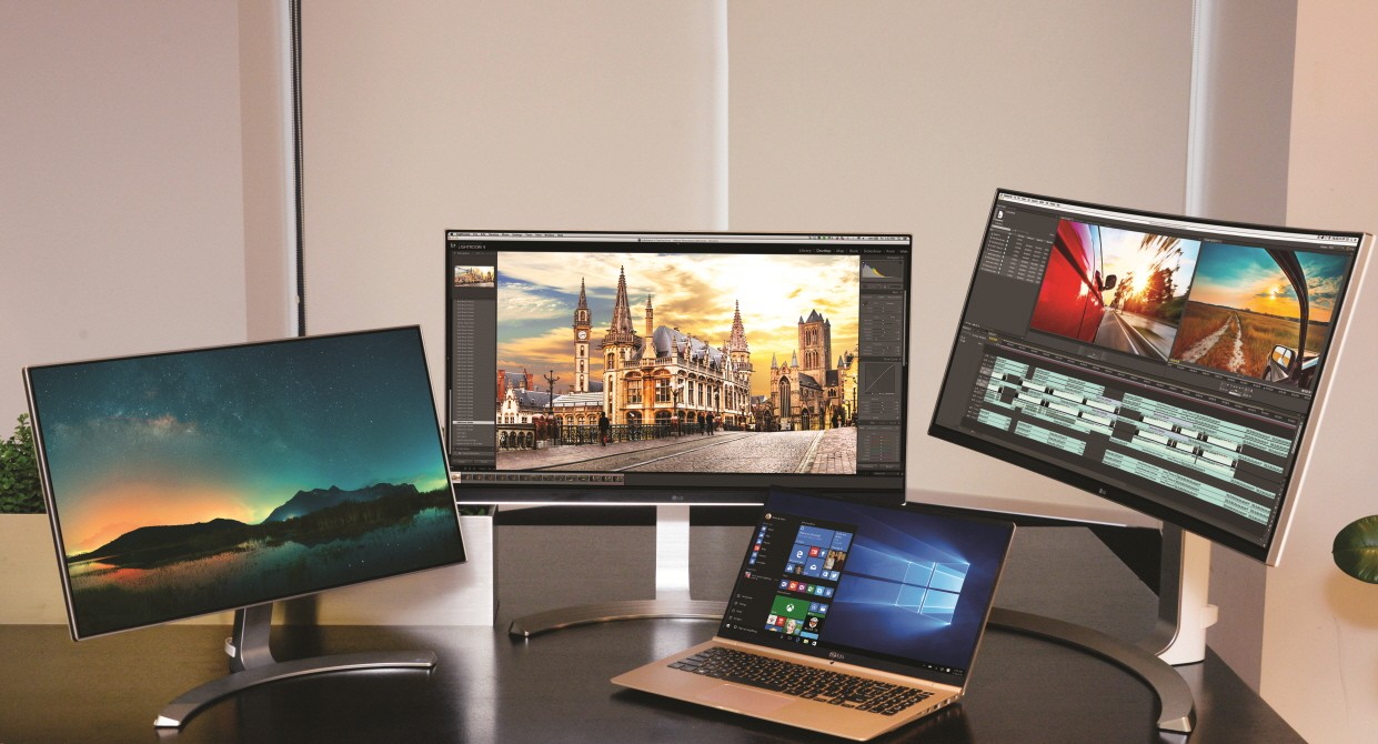 LG 2016 21:9 UltraWide™ monitor models 24MP88, 27UD88 and 34UC98, behind the LG Ultra PC gram laptop model 15Z960