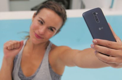 A woman is taking a selfie with the LG K10 in Indigo