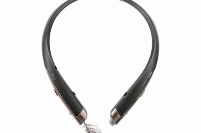 The top view of the LG TONE Platinum™ in Black with Gold trim and the left ear bud retracted from the device