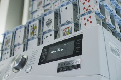 Closeup of LG Centum System™ washing machine and house of card built on it
