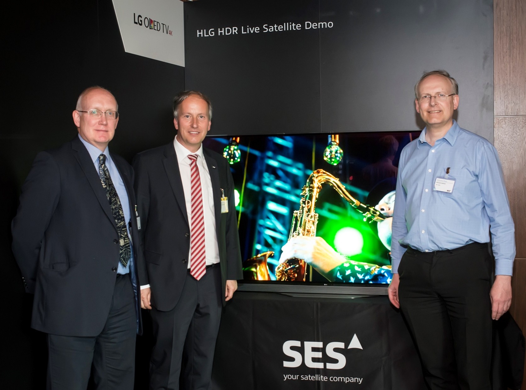 Officials of LG, BBC and SES pose in front of an LG OLED TV at the ninth SES Industry Days conference in Luxembourg.