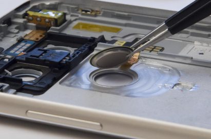 Fingerprint-scanning sensor of LG G5 held by pair of tweezers