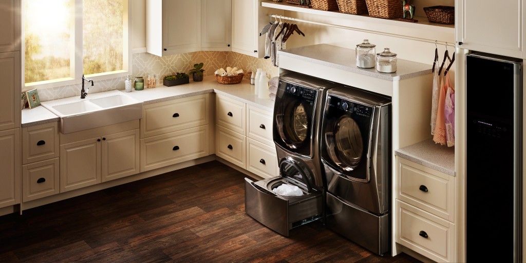 LG Styler and set of TWINWash™ washing machine and dryer fitted into a utility room.