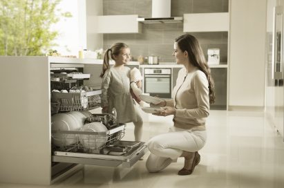 Mother and daughter taking out dishes from LG dishwasher