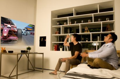 Two men playing a video game with the LG Minibeam projector