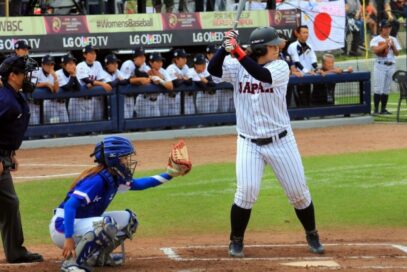 Japan player awaits pitch from South Korean rival with OLED TV logo visible above Japan’s dugout