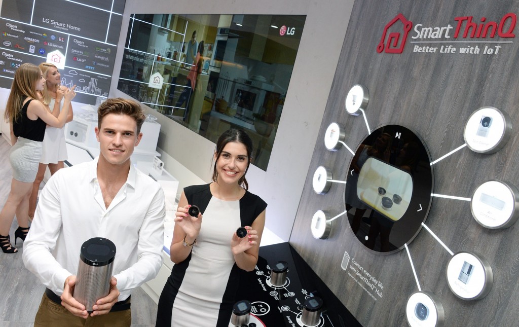 Male and female models holding SmartThinQ™ Hub and SmartThinQ™ Sensors in their hands at LG booth in IFA 2019