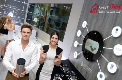 Male and female models holding SmartThinQ™ Hub and SmartThinQ™ Sensors in their hands at LG booth in IFA 2019