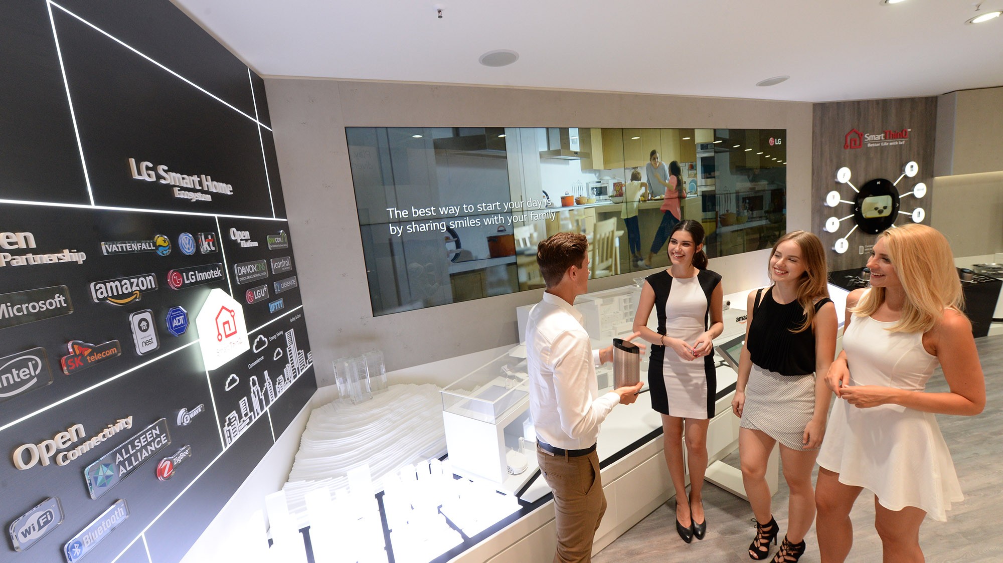 Male and female models and visitors at LG booth in IFA 2019