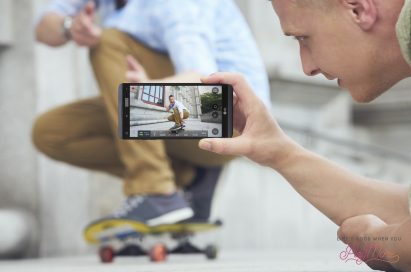 A man taking a video of a man skateboarding using the LG V20’s Steady Record 2.0 feature