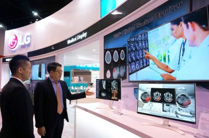 An LG staff member explains the LG Clinical Review Monitor to a visitor at RSNA® 2016