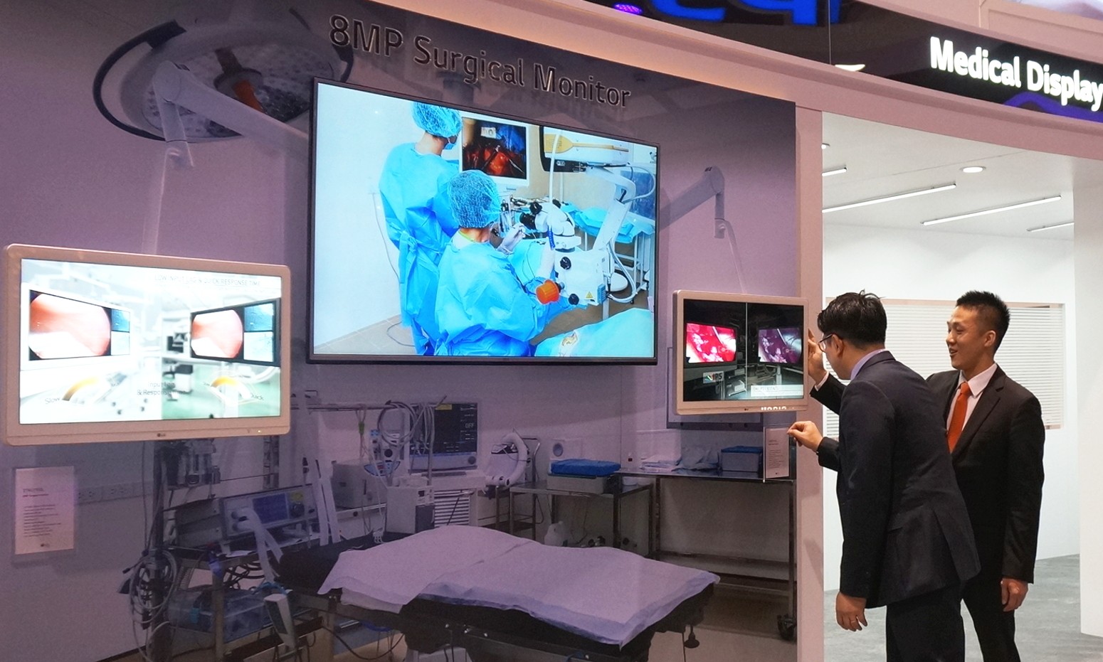 Two visitors take a closer look at the LG Surgical Monitor at RSNA® 2016