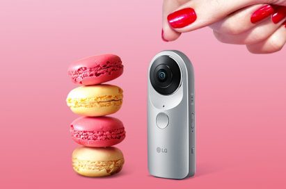 LG 360 CAM positioned next to a stack of macaroons with a woman’s hand visible above