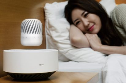 A woman leaning her head on a pillow while gazing upon the LG Levitating Portable Speaker