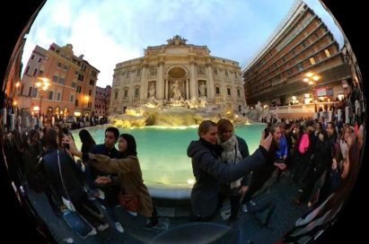 App interface of LG 360 CAM shown capturing 360-degree video footage of people at a fountain