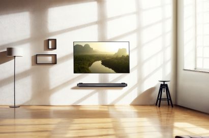 A minimalist living room scene with the LG SIGNATURE OLED TV W fitted on the wall
