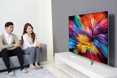 Another different shot of a couple sitting on a couch watching the LG SUPER UHD TV (model SJ95)