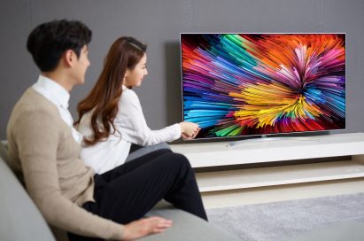 The last image of a couple sitting on a couch watching the LG SUPER UHD TV (model SJ95)