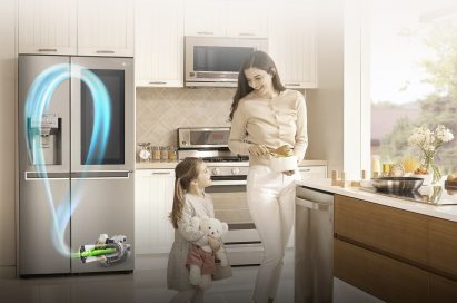A mother and daughter stand in their kitchen with the LG InstaView™ refrigerator with Inverter Linear Compressor behind them