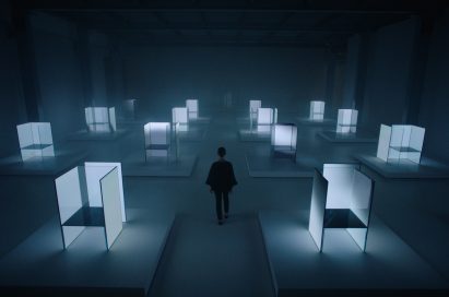 A woman walks through a number of the OLED panel installation of Tokujin Yoshioka at the exhibition venue.