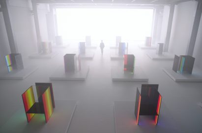 A woman walk around Tokujin Yoshioka’s art exhibition hall which is blurred by the fog effect.
