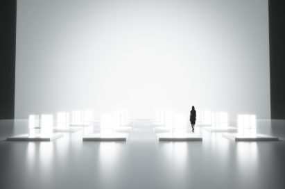 A woman is seen in the background walking beside the back wall of Tokujin Yoshioka’s art exhibition, which boasts thousands of bright lights.