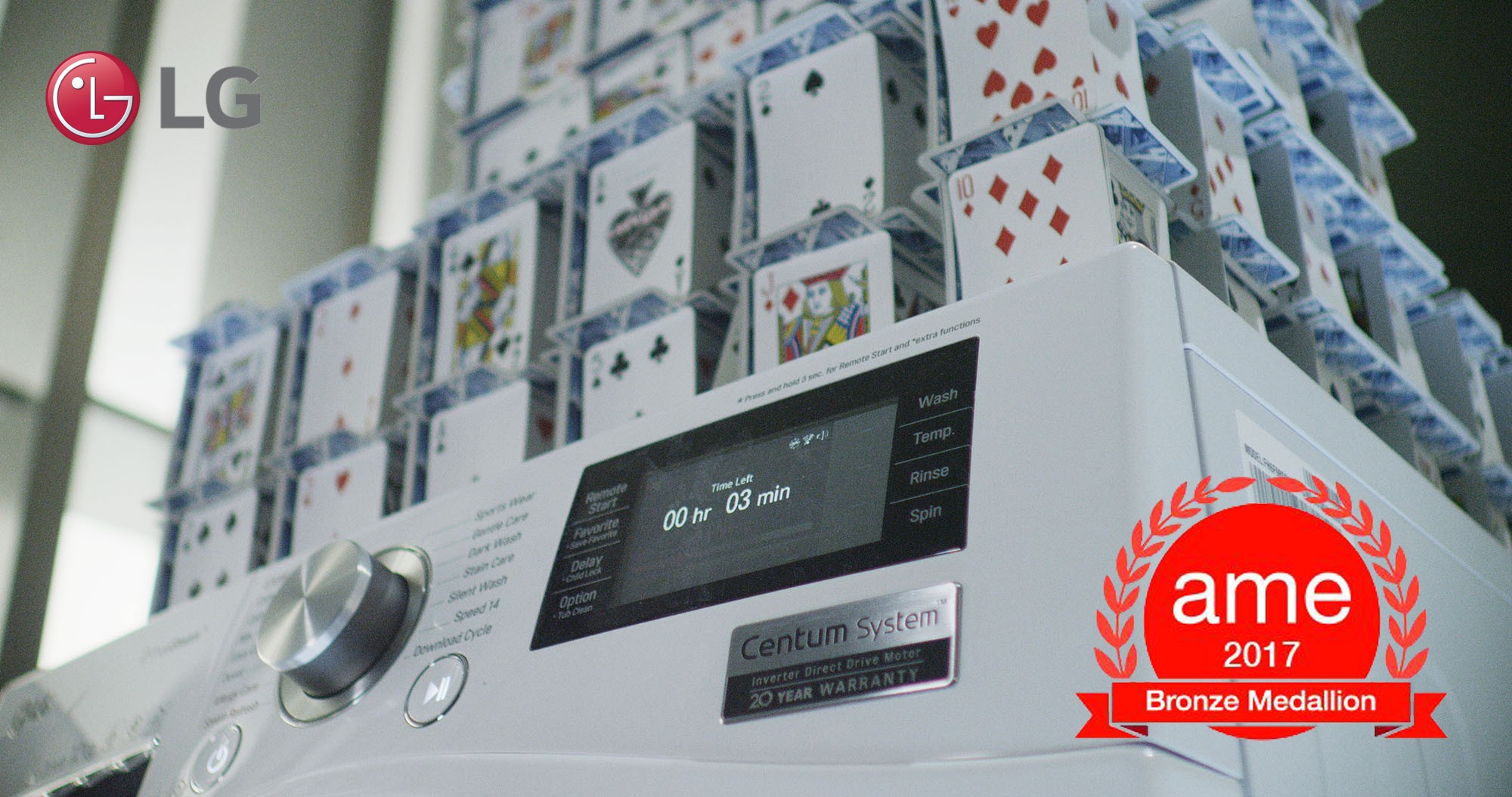 Closeup of LG Centum System™ washing machine and house of card built on it with AME Award 2017 logo featured