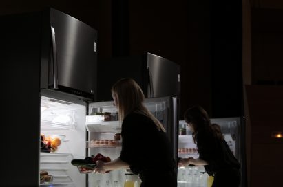 Two female musicians take food from LG’s advanced refrigerators.