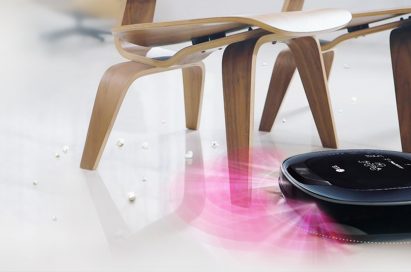 LG HOM-BOT Turbo+ navigating its way under two chairs