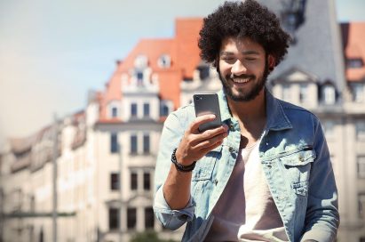 A man looking at the LG G6 in his hand