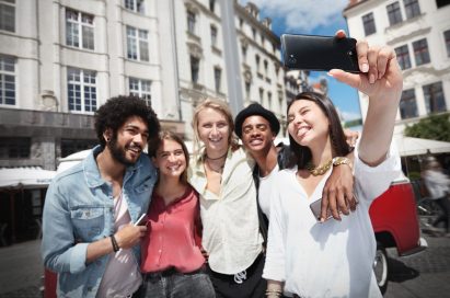 A group of friends are taking a selfie with the LG Q6 in Astro Black