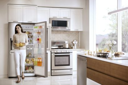 Woman taking a basket of fruit out of the LG InstaView Door-In-Door™ refrigerator’s main compartment