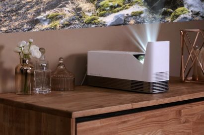 The LG ProBeam Projector model HF85J placed on top of living room furniture