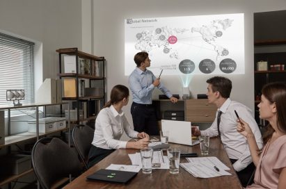 A work team use the LG Probeam Projector for their meeting in the office
