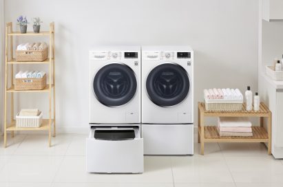 One LG washing machine with the TWINWash™ Mini unit open next to LG dryer with the pedestal unit closed in a laundry room