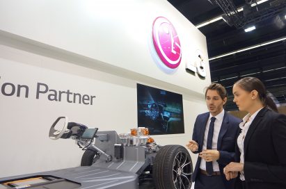 A lady and gentleman discuss LG Vehicle Component technology in front of the LG booth at the Frankfurt Motor Show.