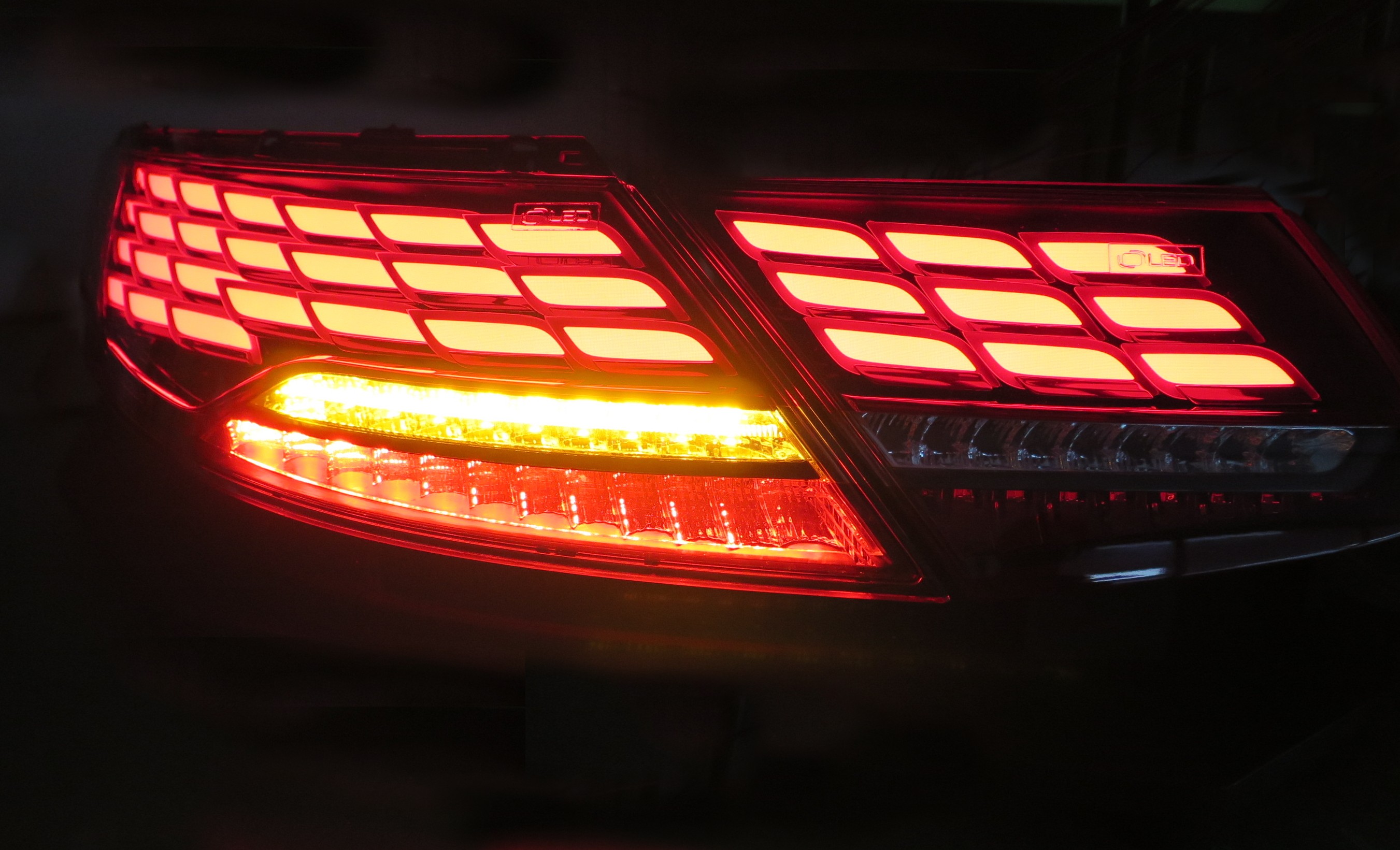 The same vehicle rear lamp displayed in the dark to show its brake and car indicator lights in action at the Frankfurt Motor Show.