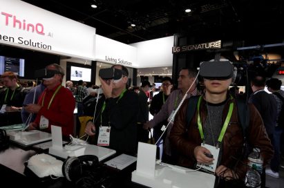 Visitors testing the VR devices connected to LG smartphones in LG’s CES booth