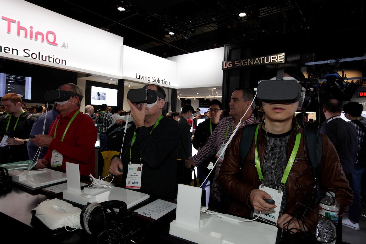 Visitors testing the VR devices connected to LG smartphones in LG’s CES booth