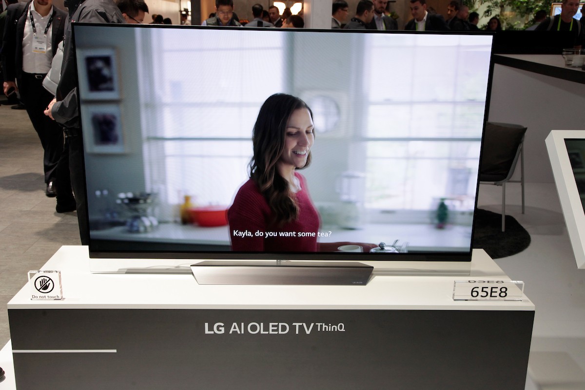 A closeup of the LG AI OLED TV ThinQ positioned on the promotional stand at the LG booth, CES 2018