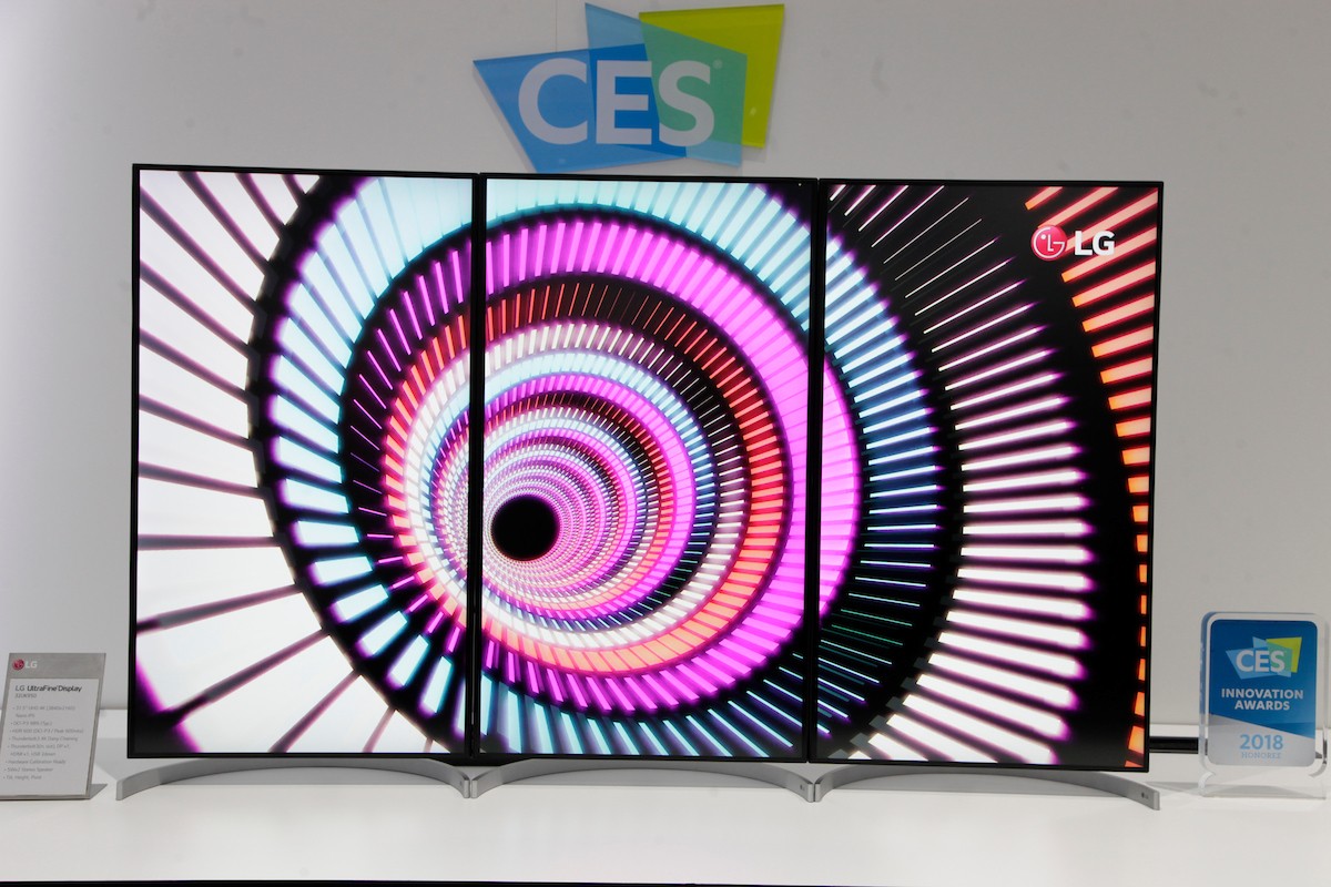 Front view of three 32-inch UltraFine Displays in their portrait mode to form one large 55-inch screen, which stands next to a 2018 CES Innovation Award