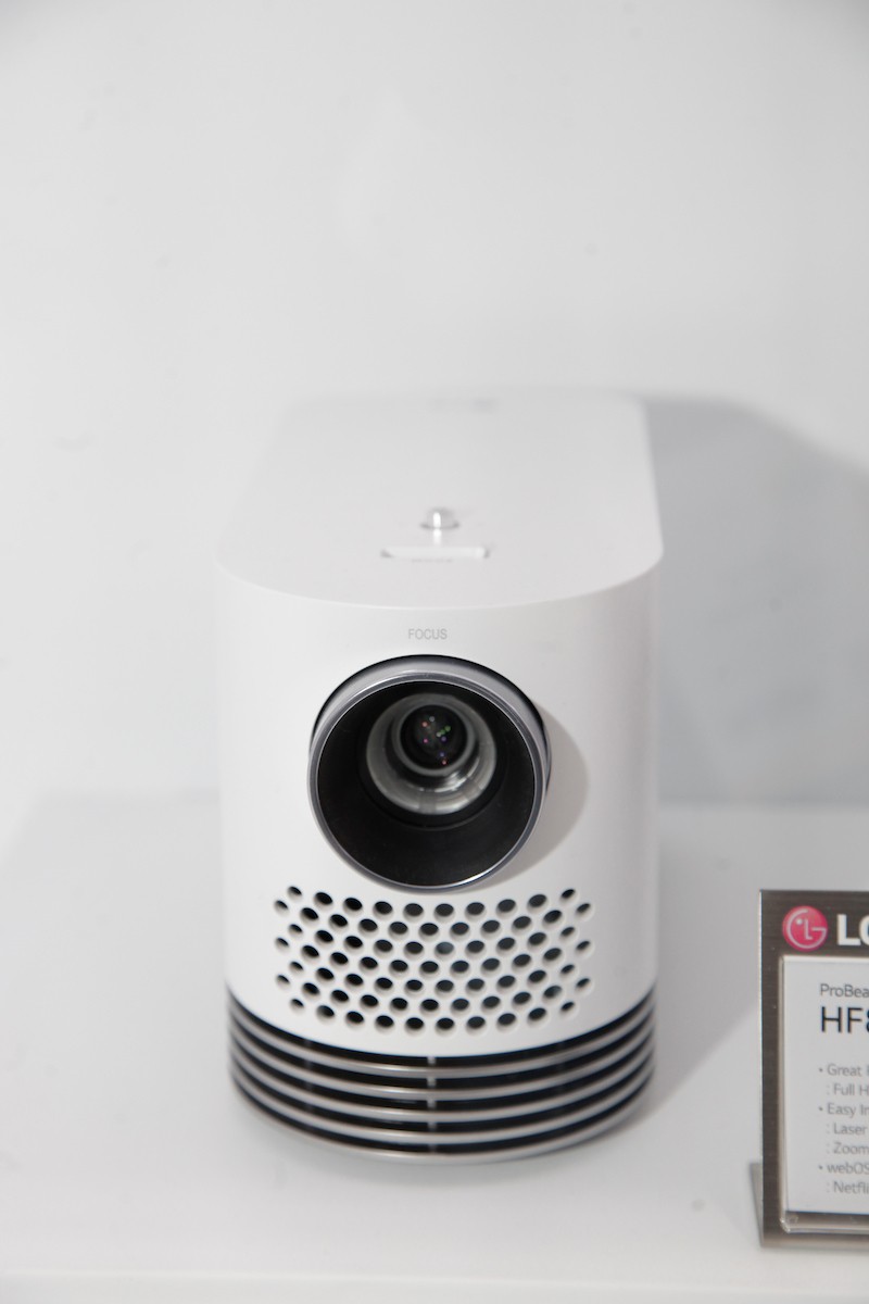 Front view of LG’s ProBeam HF80LG projector placed next to its nameplate
