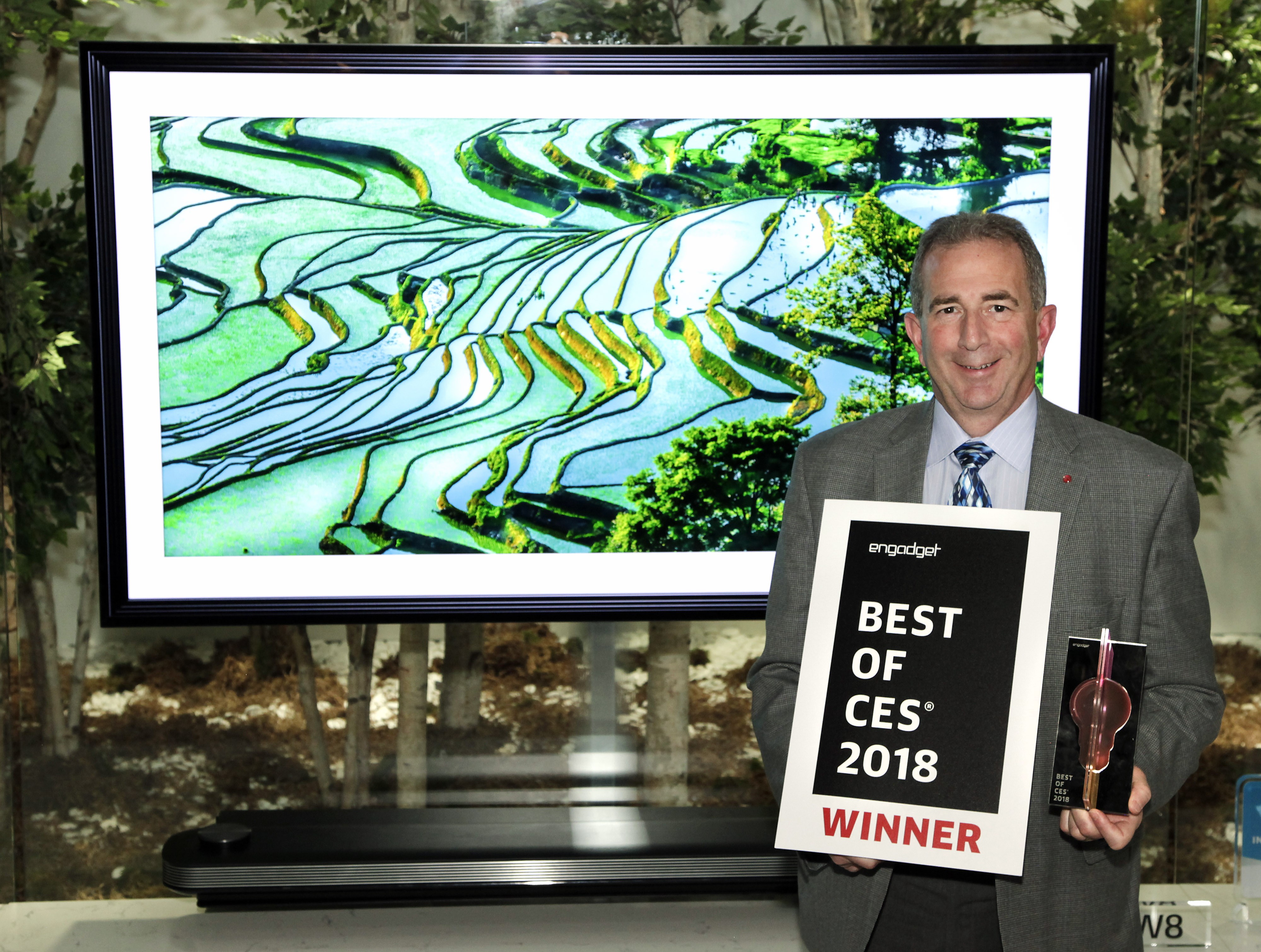 Tim Alessi, LG Electronics’ USA head of Product Marketing for Home Entertainment products, poses with two awards, one being Engadget’s Best of CES 2018 certificate.
