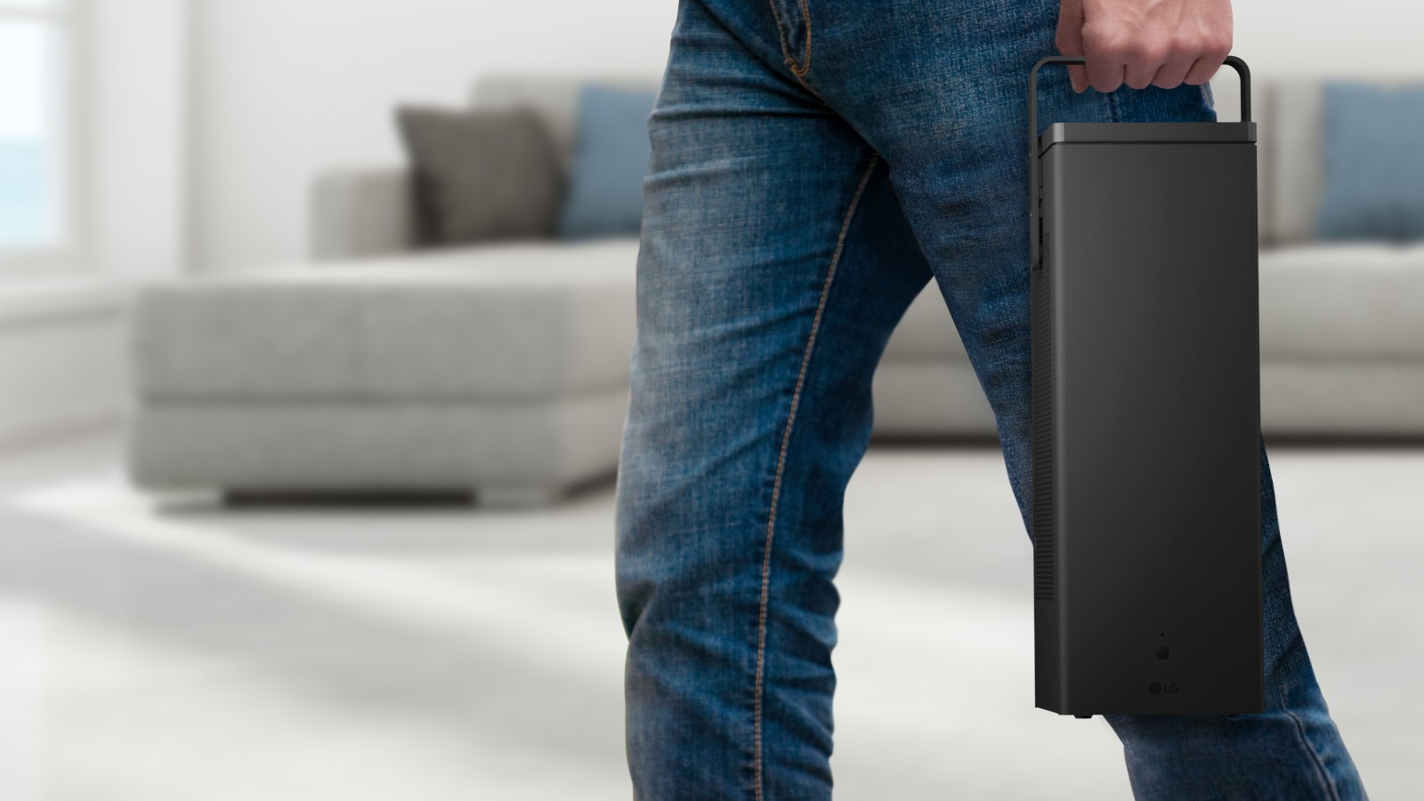 A man carrying the highly portable LG 4K UHD Projector in one hand